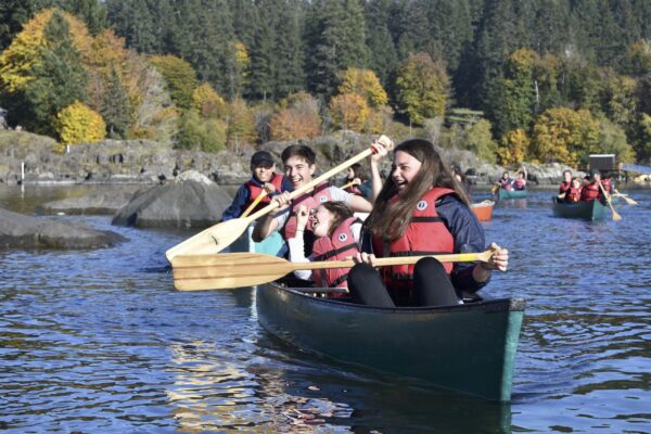 Students smiling and having fun kayaking